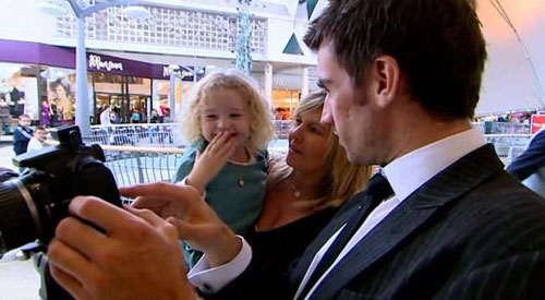 Cute little girl checks her photo on The Apprentice