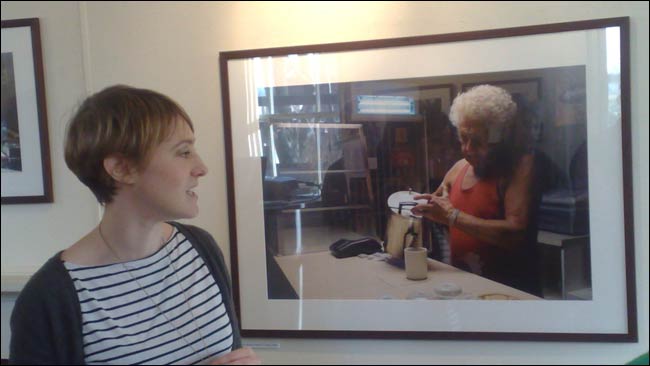 Katherine Green standing next to her picture of John Denahy