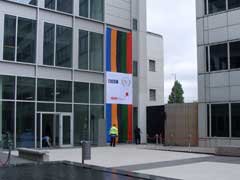 The plaque covered up by an olympic themed flag