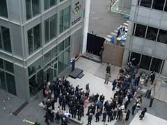 Mark Thompson and Jacques Rogge pose for photographs in front of the BBC Broadcast Centre's Olympic plaque