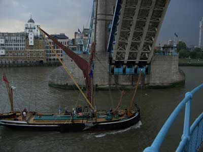 A crowd on the sail barge wave up at the control room on Tower Bridge