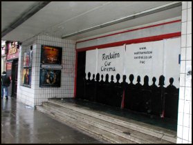 Spray-paint of a cinema audience on the now closed doors of the cinema