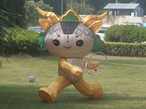 An Olympic mascot plays tennis