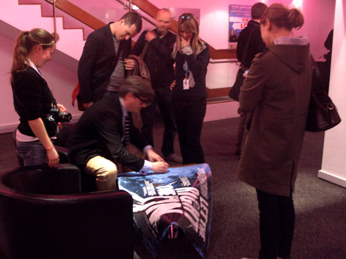 Tomas Alfredson signing a film poster for the Barbican